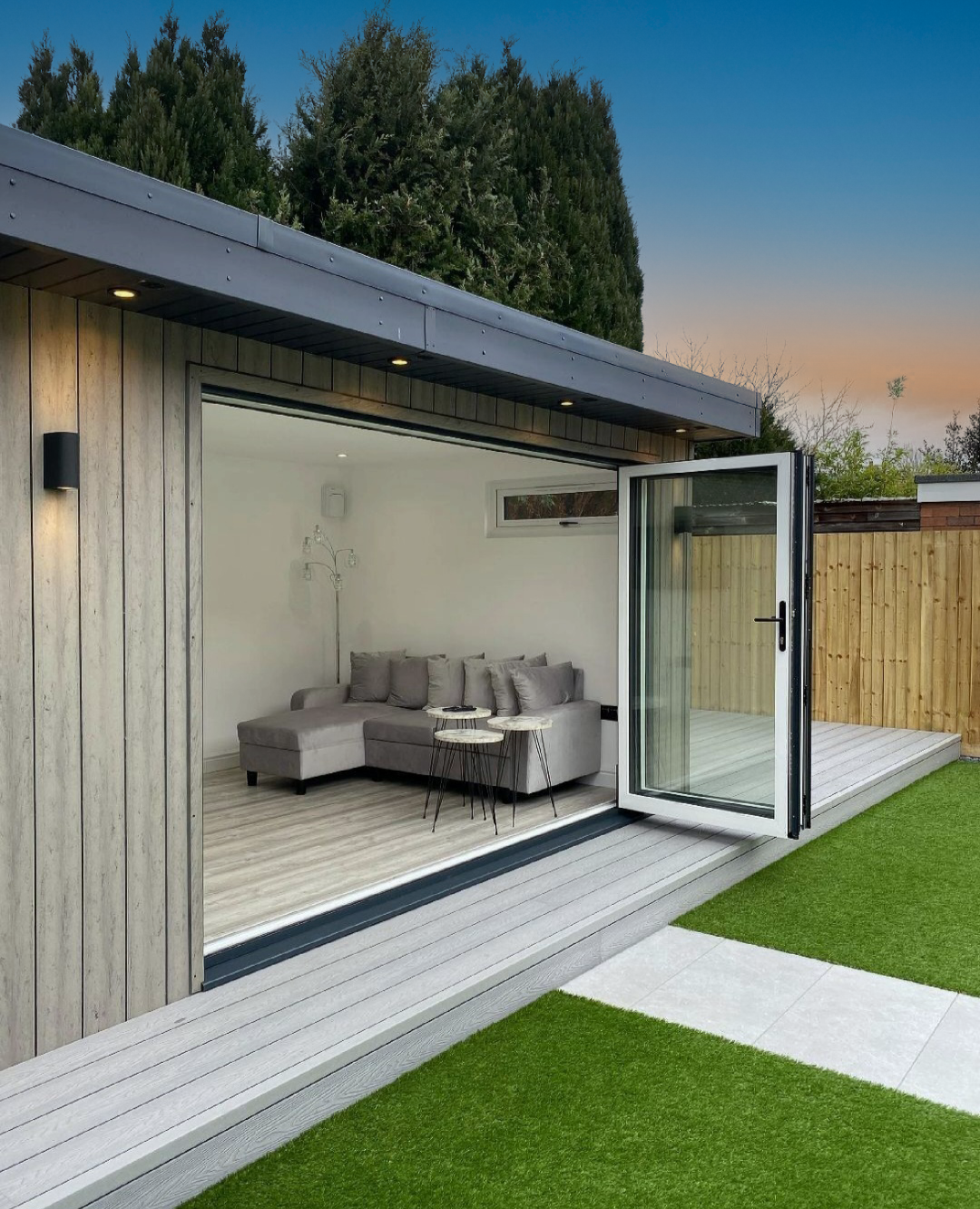 Relaxing garden room cladded with Foritz composite cladding in Duo Grey colour